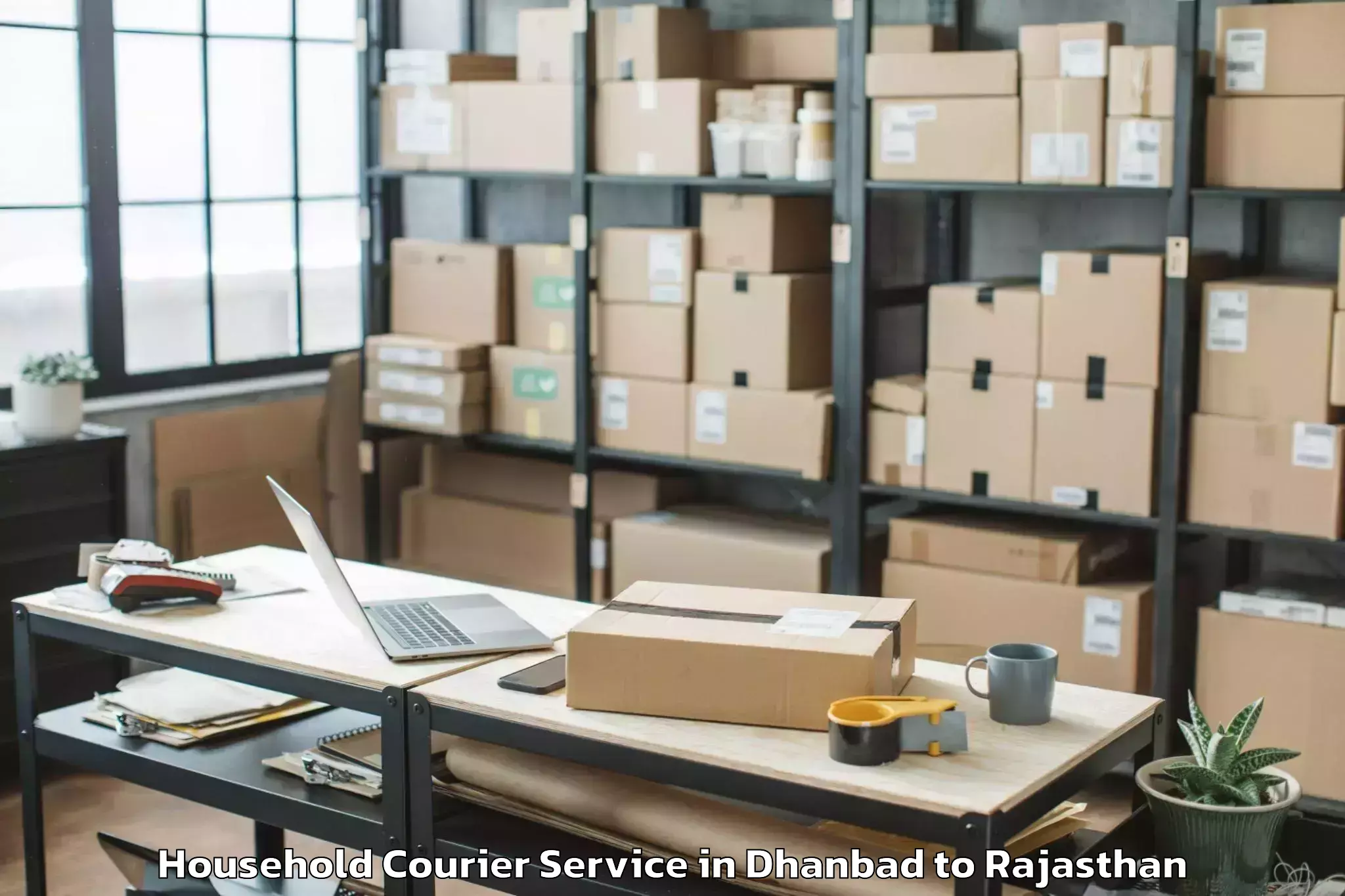 Top Dhanbad to Rajakhera Household Courier Available